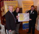 Lion President Steve presenting the Devon Free Wheelers with a cheque for 1000