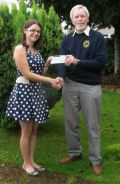 Lion Tom presenting Charlotte Miller-Ratcliffe with cheque for 100