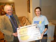 Lion President Steve Presenting the cheque to Natalie Searle from Marie Curie
