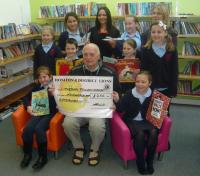 Lion Ron presenting cheque for £250 towards new library