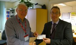 Lion Bob presents 100 to Matt Burrell from Honiton College for Senior citizens xmas party