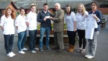 Lion Ron Webb presenting cheque and named T shirts to Andy Taylor Head PE and Sports