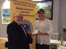 Past President Brian presents £1000 to The Project