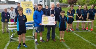 Lion President Steve presenting Andy Taylor Head of Sport & PE with £500