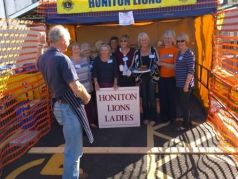 Lions Ladies line up in plate smashing stall ahainst Lion President Steve